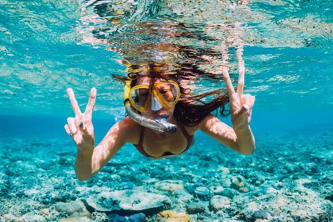 A snorkeller in the clear shallow water of an Amalfi Coast cove